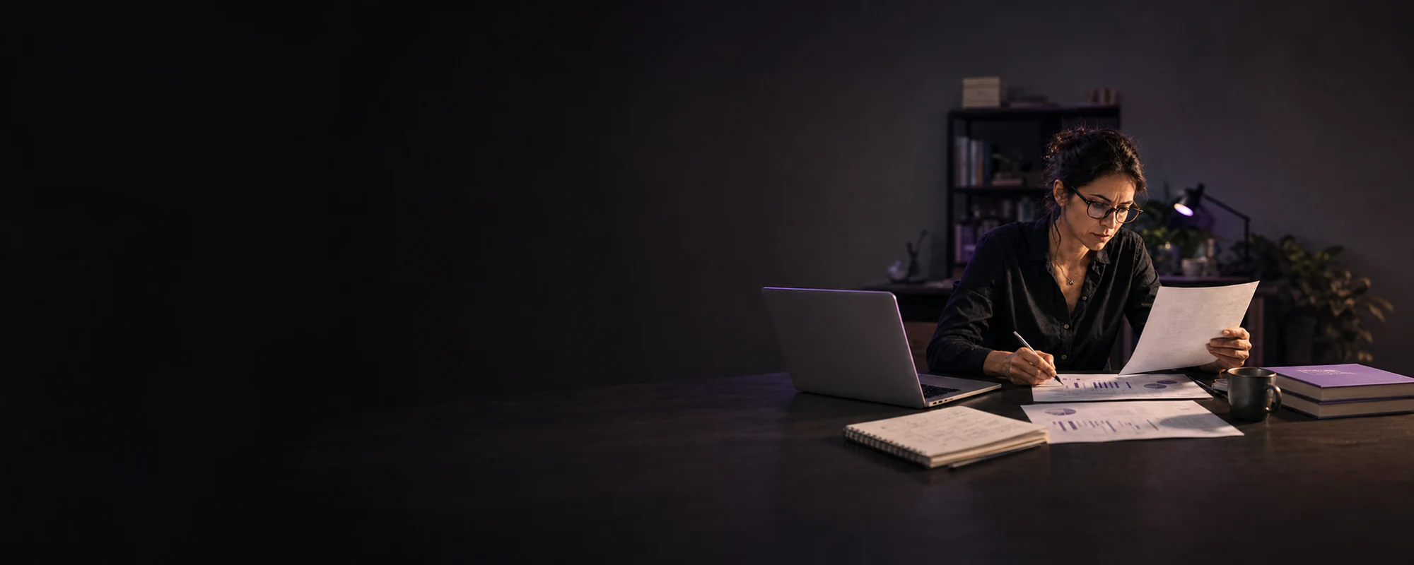 Professional reviewing an AI-assisted draft against printed evidence in a purple-lit workspace